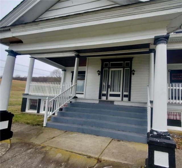 view of exterior entry featuring a porch