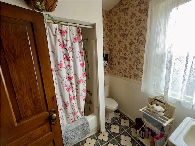 bathroom with shower / tub combo, tile patterned floors, and toilet