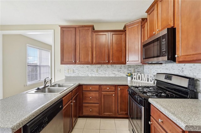 kitchen with tasteful backsplash, appliances with stainless steel finishes, light tile patterned flooring, and sink