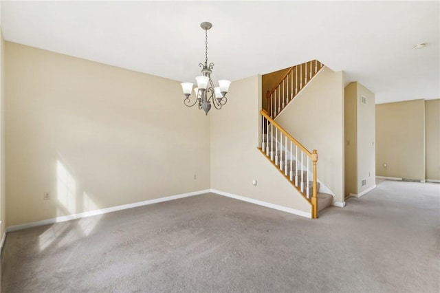 carpeted empty room with a notable chandelier