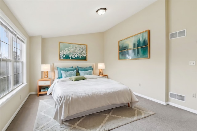 carpeted bedroom with vaulted ceiling