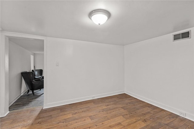 spare room with hardwood / wood-style flooring