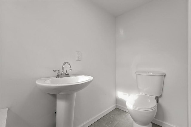 bathroom with tile patterned floors and toilet