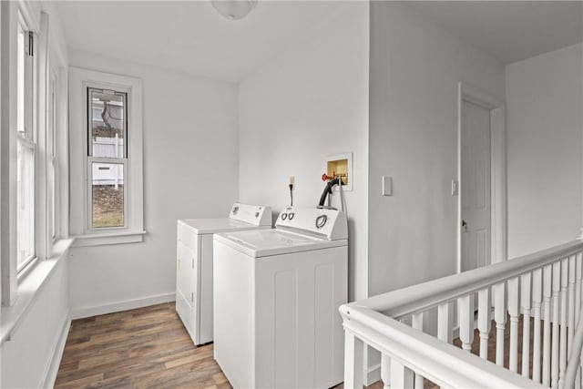 laundry room with hardwood / wood-style floors and washing machine and dryer