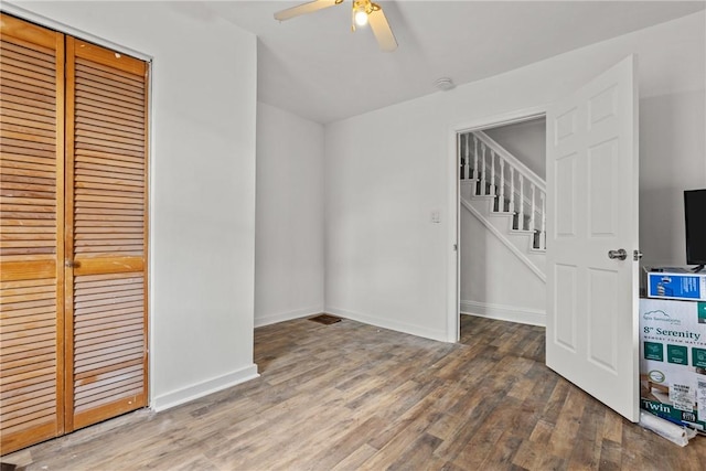 interior space with wood-type flooring and ceiling fan