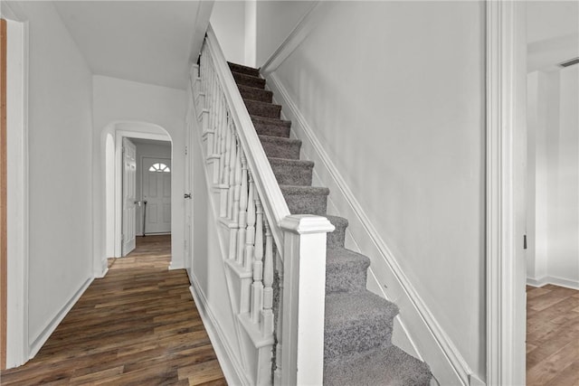 stairs featuring wood-type flooring