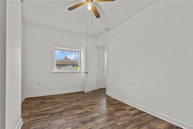 empty room featuring ceiling fan and dark hardwood / wood-style floors