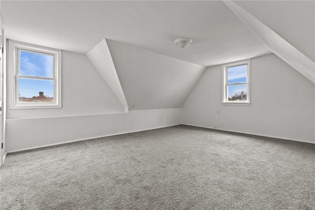 bonus room with lofted ceiling and carpet floors