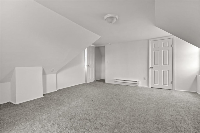 additional living space with vaulted ceiling, carpet, and a baseboard heating unit