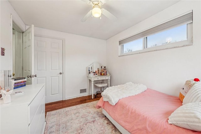 bedroom with a ceiling fan, visible vents, and light wood finished floors