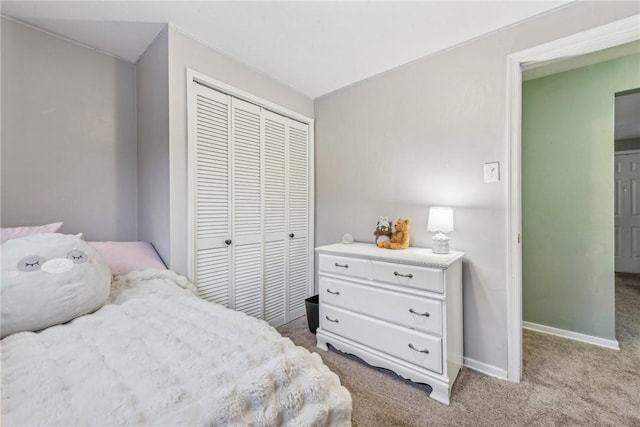 bedroom featuring light colored carpet and a closet