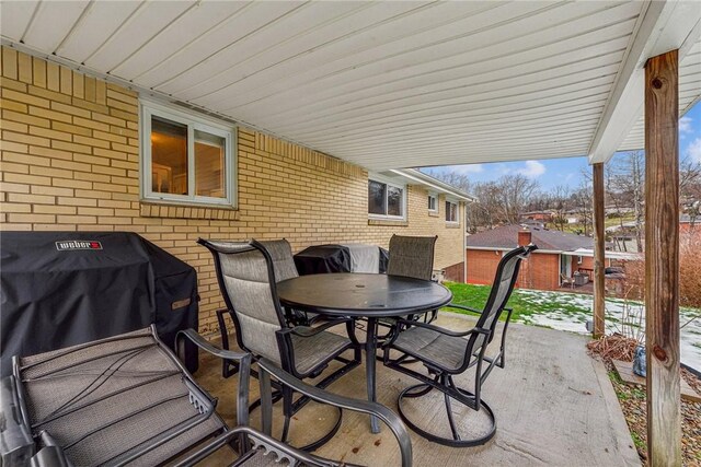 view of patio / terrace featuring outdoor dining space and a grill