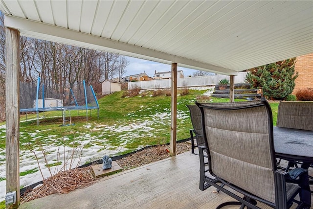 view of patio / terrace featuring a trampoline and a storage unit