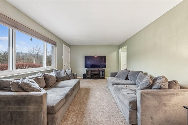 living room featuring baseboards and light colored carpet