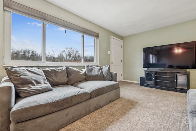 living area featuring carpet floors and baseboards