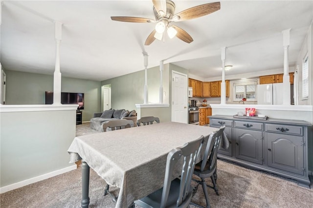 dining area with ceiling fan, carpet, and baseboards