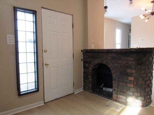 foyer entrance featuring a notable chandelier and light hardwood / wood-style flooring