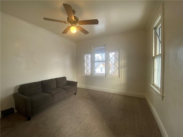 carpeted living room with crown molding, ceiling fan, and plenty of natural light