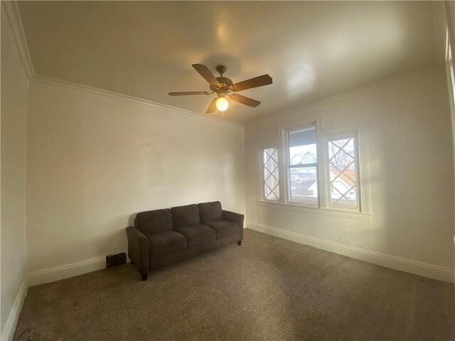 unfurnished room with dark colored carpet, ceiling fan, and crown molding