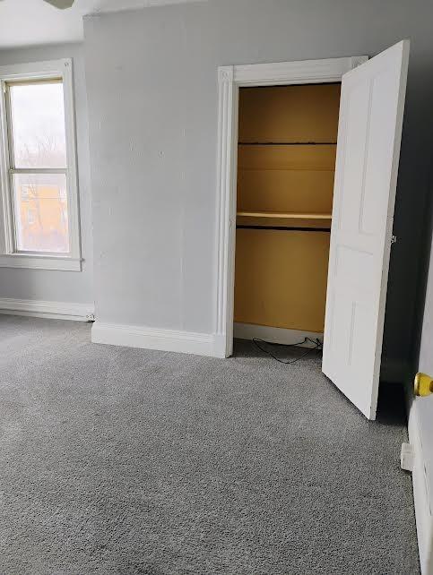 unfurnished bedroom with carpet floors and a closet