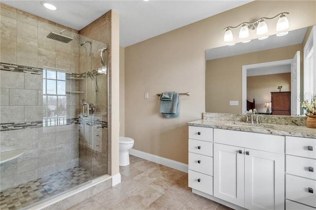 bathroom featuring vanity, toilet, and an enclosed shower