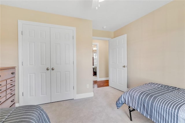 bedroom with light colored carpet and a closet