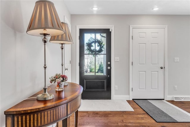 foyer entrance with dark hardwood / wood-style floors