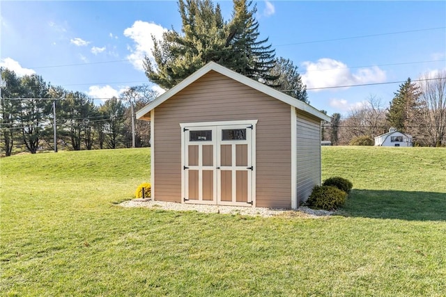 view of outbuilding featuring a lawn