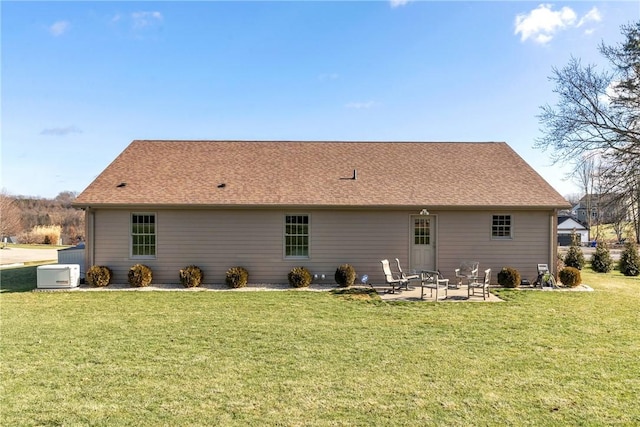 rear view of property with a patio area and a lawn