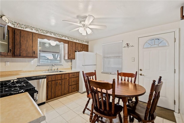 kitchen with sink, ceiling fan, white refrigerator, decorative backsplash, and stainless steel dishwasher