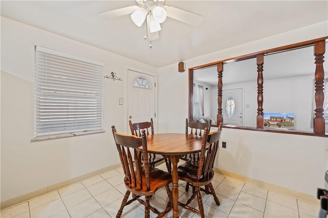 tiled dining space featuring ceiling fan