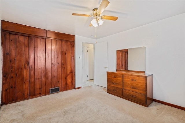 unfurnished bedroom featuring ceiling fan and light carpet