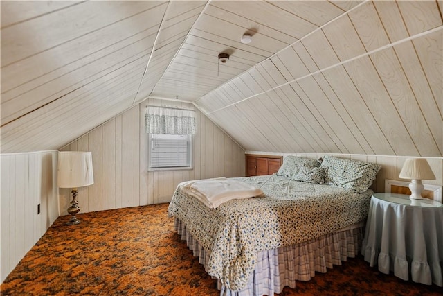 bedroom featuring wood ceiling, lofted ceiling, wooden walls, and dark carpet