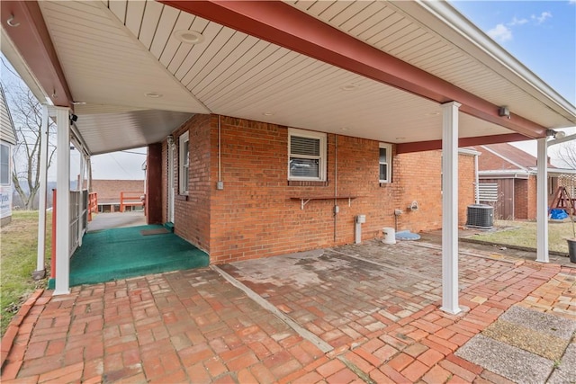 view of patio with a carport, a shed, and central air condition unit