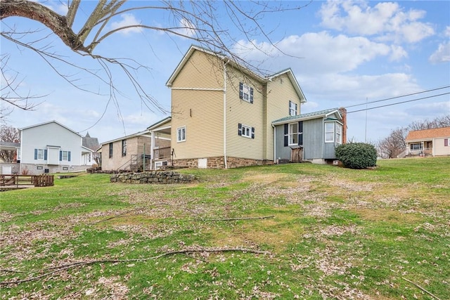 rear view of house with a yard