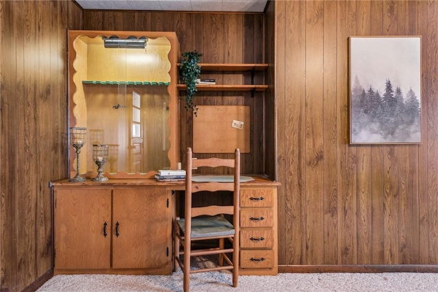 office space with light colored carpet and wood walls