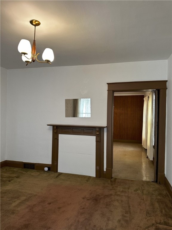 unfurnished living room with light colored carpet and a notable chandelier