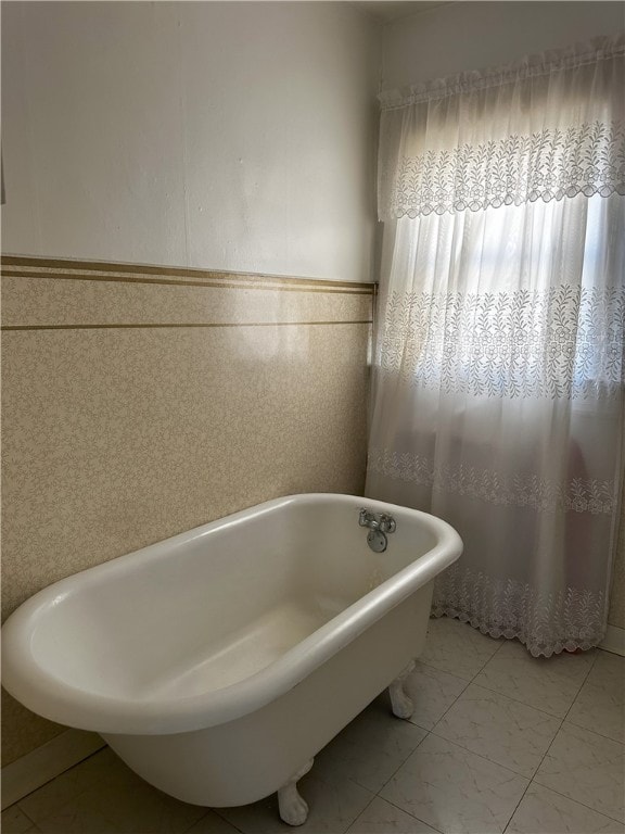 bathroom with tile walls and a tub to relax in