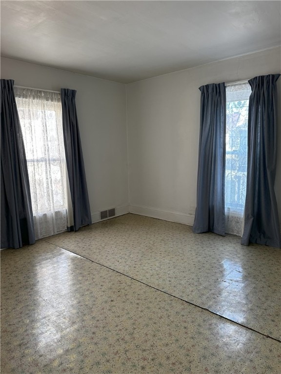 spare room featuring plenty of natural light