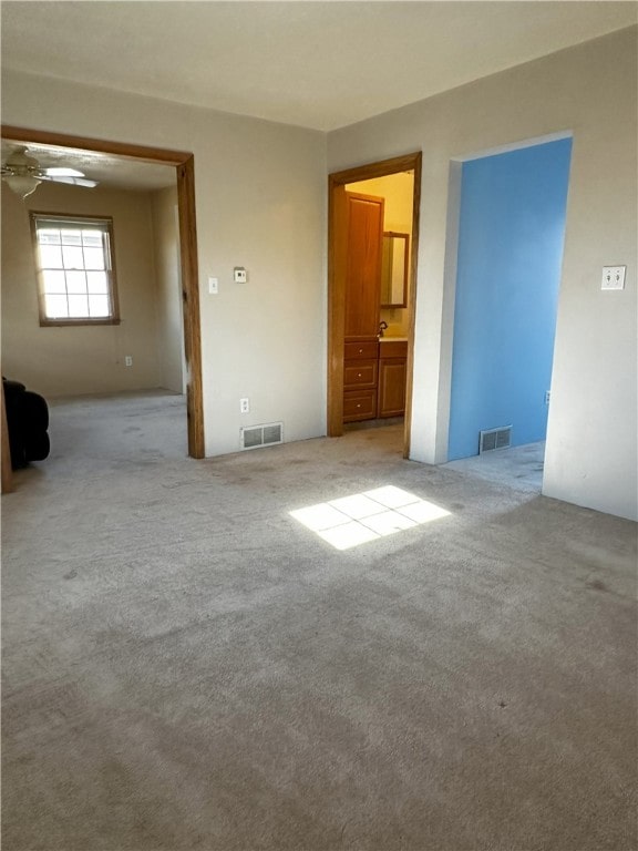 unfurnished room with light colored carpet