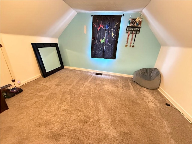 carpeted cinema room featuring lofted ceiling