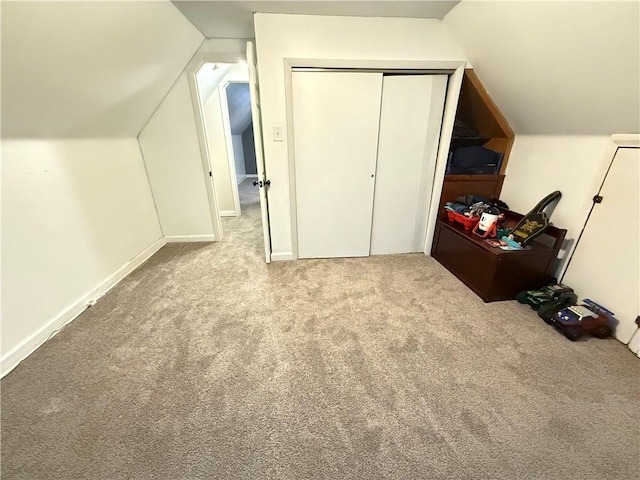 bonus room featuring lofted ceiling and light carpet