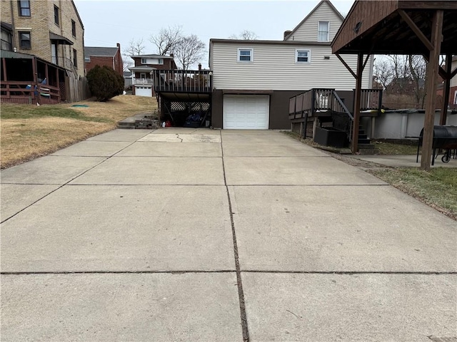 view of property exterior featuring a wooden deck and a garage