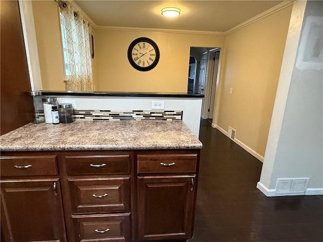 bathroom with hardwood / wood-style flooring, crown molding, and backsplash