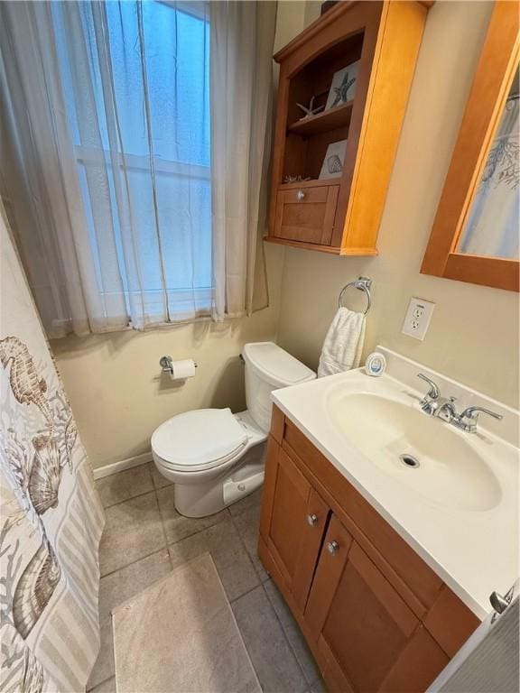 bathroom featuring tile patterned flooring, vanity, and toilet