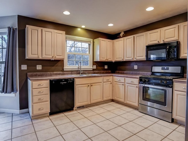 kitchen featuring light tile patterned flooring, sink, and black appliances