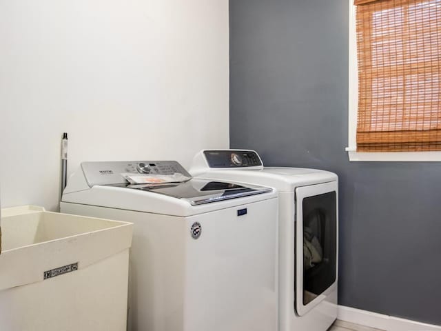 clothes washing area featuring sink and washer and clothes dryer