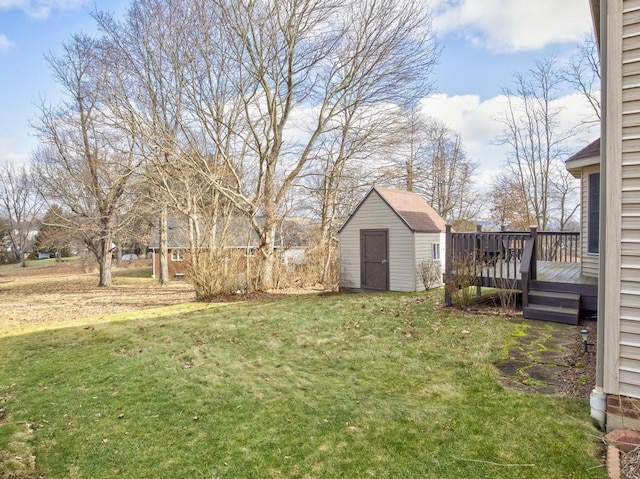 view of yard with a deck and a storage shed