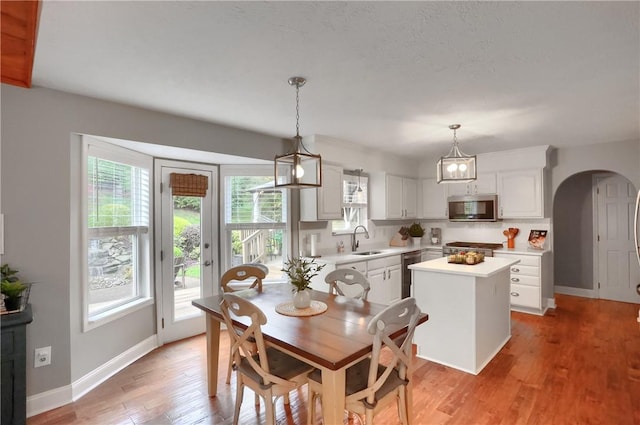 dining room featuring sink and light hardwood / wood-style flooring