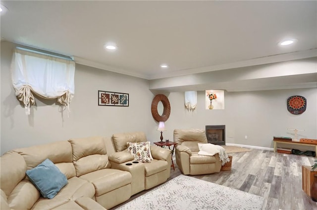 living room featuring hardwood / wood-style floors and crown molding